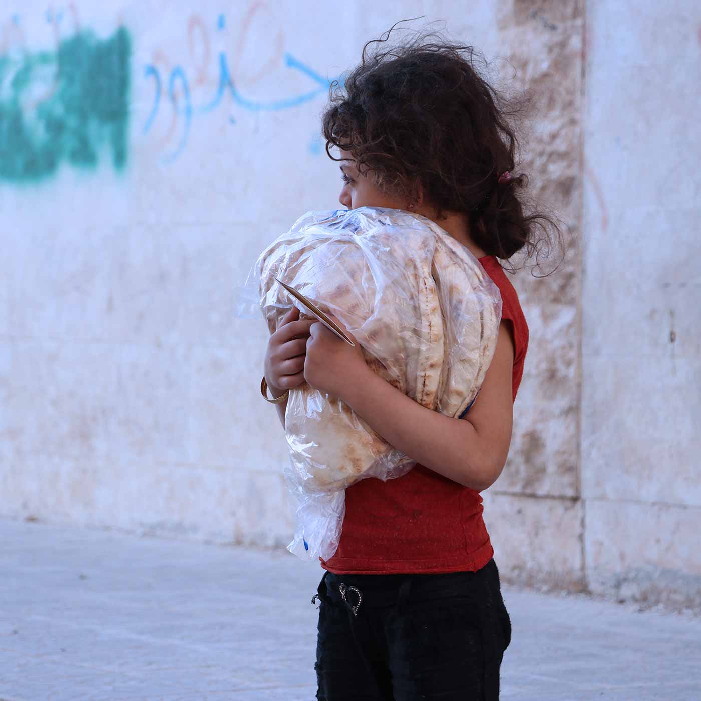 Girl in Idlib Syria with Bread